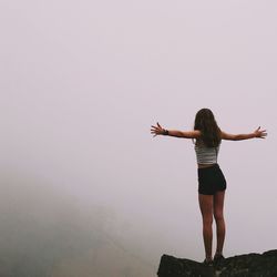 Full length of young woman standing on ground