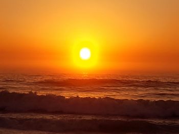 Scenic view of sea against romantic sky at sunset