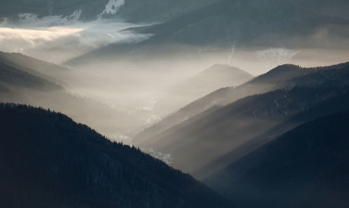 Scenic view of mountains against sky during winter