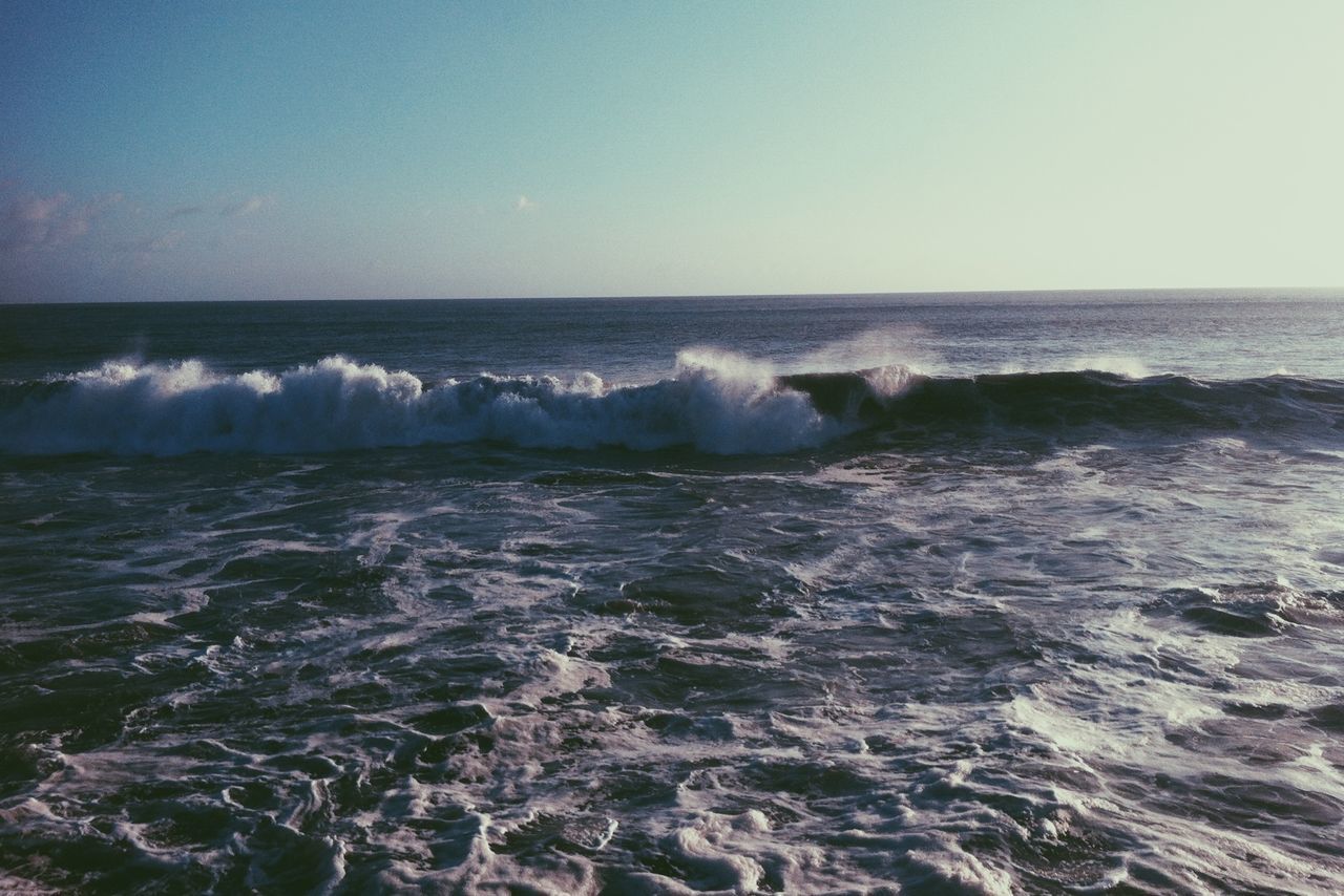 sea, water, horizon over water, wave, clear sky, surf, scenics, beauty in nature, motion, copy space, splashing, nature, beach, tranquil scene, tranquility, shore, idyllic, seascape, waterfront, rock - object