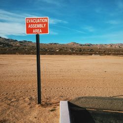 Low angle view of road sign against sky