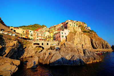 Panoramic view of buildings and sea against clear blue sky