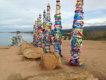 Stack of rocks on beach against sky