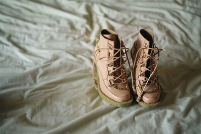High angle view of shoes on bed