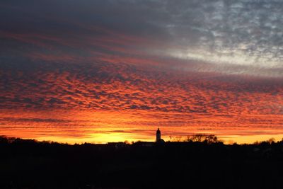 Silhouette landscape against romantic sky at sunset