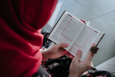 Midsection of man reading book