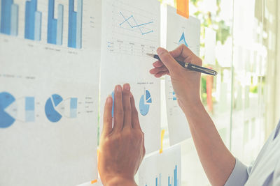 Hands of businesswoman planning on graph at office