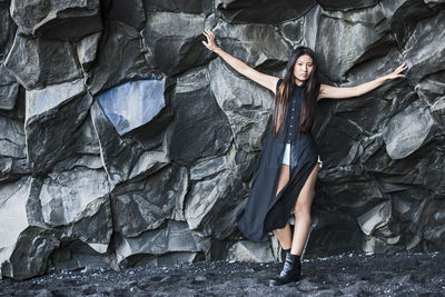 Beautiful woman posing on basalt rocks in iceland