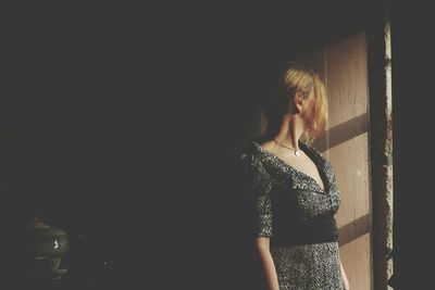 Woman standing against wall