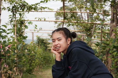 Portrait of smiling boy against plants