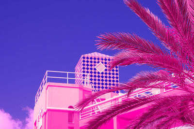 Low angle view of palm tree against clear blue sky