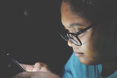 Close-up of woman using mobile phone at night