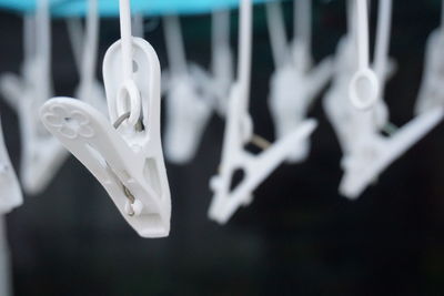 Close-up of clothespins hanging on clothesline