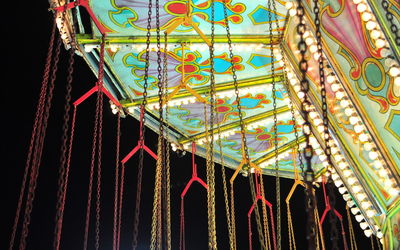 Low angle view of illuminated chandelier at amusement park