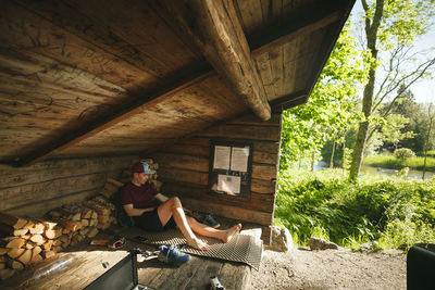 Young man at campsite barefoot