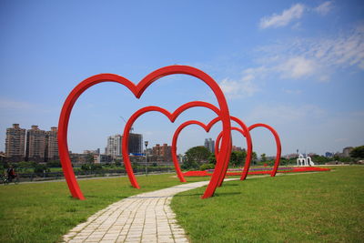 Footpath in park against sky