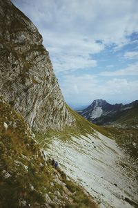 Scenic view of mountains against cloudy sky