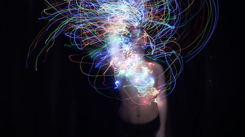 Low angle view of light painting against black background