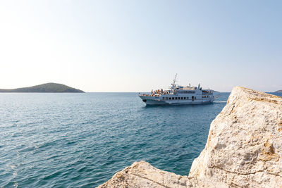 Yacht sailing in sea against clear sky