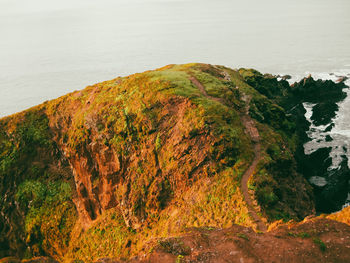 High angle view of rock formations by sea