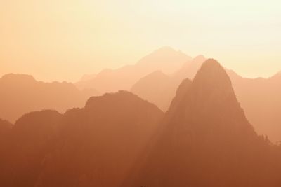 Silhouette mountains against sky during sunset