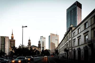 View of city street and buildings against sky