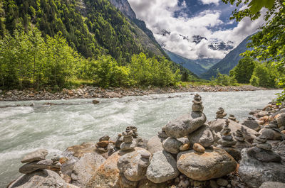 Scenic view of rocks in lake against mountains