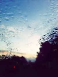 Reflection of clouds in sea at sunset