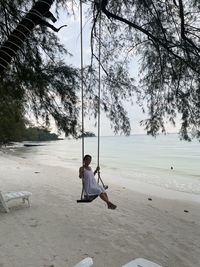 Woman on swing at beach