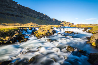 Scenic view of stream in lake against sky
