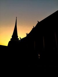 Low angle view of silhouette building against sky during sunset