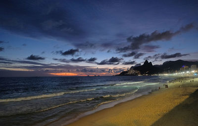 Scenic view of beach against sky during sunset