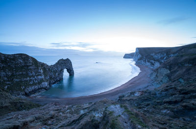 Scenic view of sea and mountains against sky