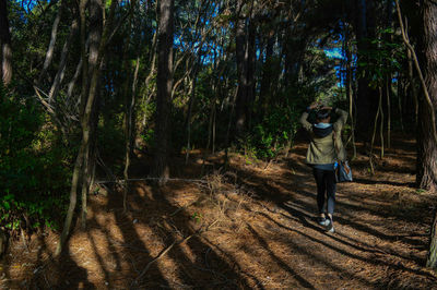 Woman standing in forest