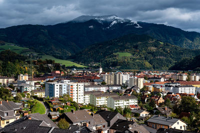 High angle view of townscape and mountains against sky