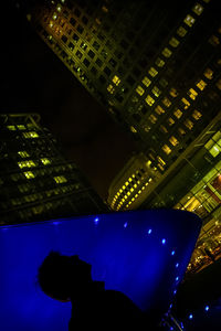 Low angle view of illuminated modern buildings in city at night