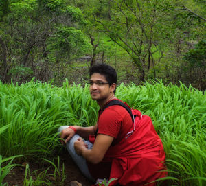 Portrait of young man sitting on grass