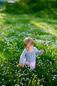 Full length of cute baby girl on grassy field