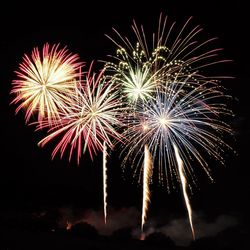 Low angle view of firework display at night