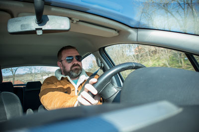 Rear view of man driving car