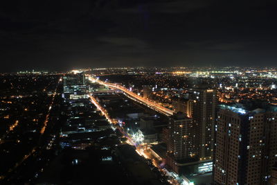 High angle view of illuminated buildings in city at night