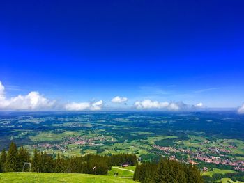 Scenic view of landscape against blue sky