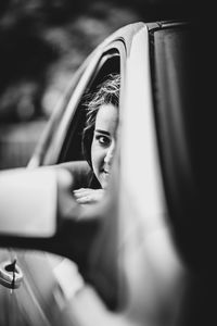 Portrait of woman sitting in car