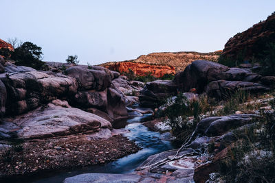 Scenic view of rocks and mountains against clear sky