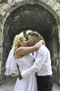 Midsection of couple standing by archway