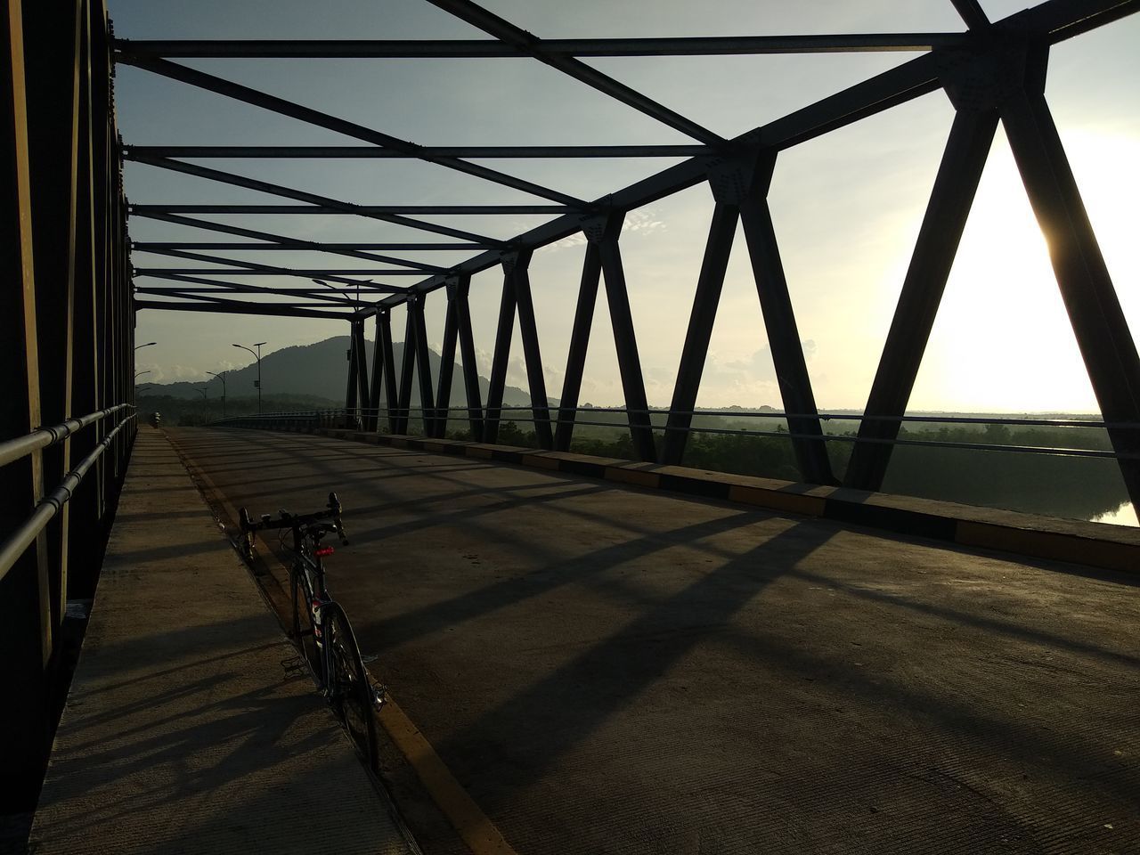 VIEW OF BRIDGE OVER ROAD AGAINST SKY