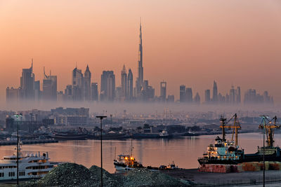 View of buildings in city at sunset