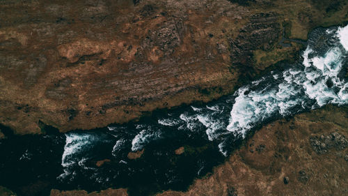 High angle view of river flowing amidst rock formations