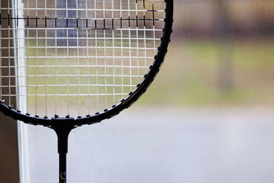 Badminton racket standing in the window with blurry background