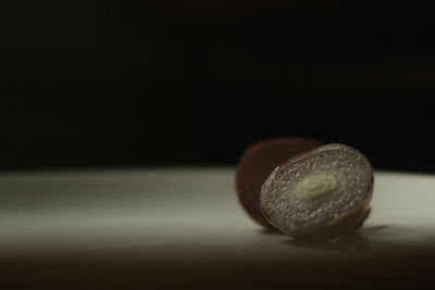 Close-up of fruit on table against black background